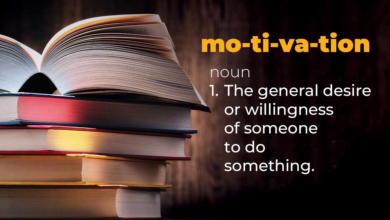 An open book on top of a stack of closed books with a wooden background. Text reads: motivation, noun, 1. The general desire or willingness of someone to do something.