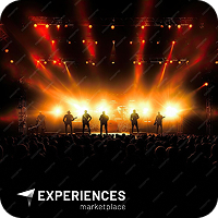 A band performs on stage with bright yellow and orange lights creating a dramatic background. The silhouettes of the musicians are visible against the illuminated backdrop, and a large crowd is gathered in the foreground. Text in the corner reads Experiences Marketplace.