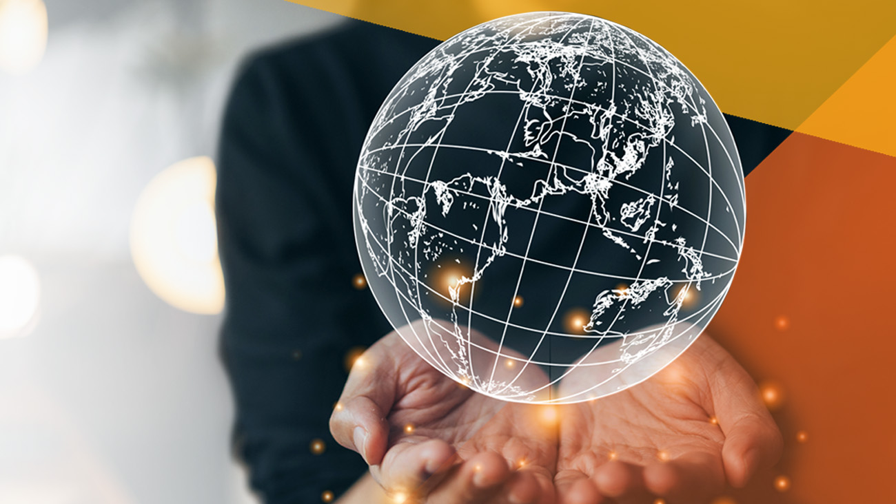 Hands are holding up a transparent globe with glowing points, symbolizing global connection. The background is blurred, and geometric orange shapes add a modern touch.