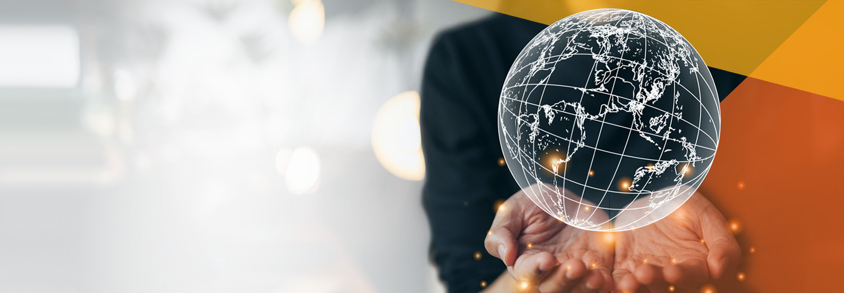 A person holds out their hands, with a glowing digital globe displaying world map outlines hovering above their palms. Abstract orange and white shapes are in the background.